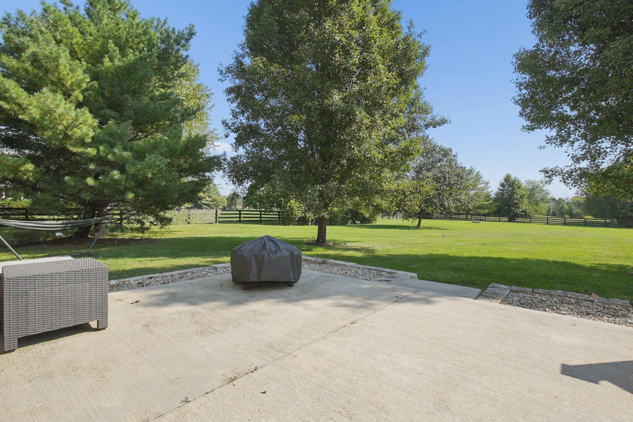 9435 Concord Road Powell, OH 43065 - Photo 63 of 77 Expansive concrete patio with gravel border and broad green lawn
