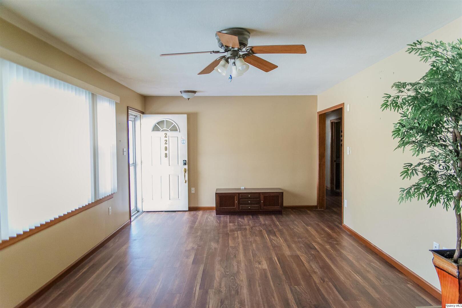 2208 Cherry Lane Quincy, IL 62301 - Photo 3 of 10 a view of empty room with wooden floor and ceiling fan