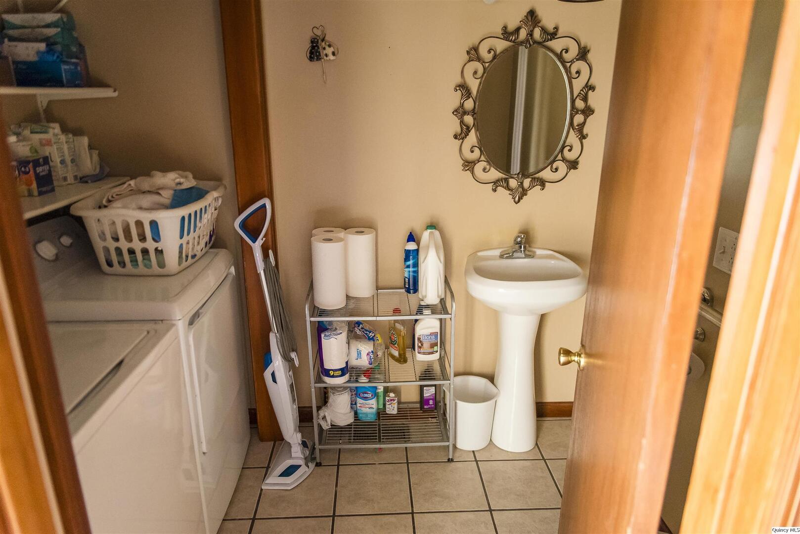 2208 Cherry Lane Quincy, IL 62301 - Photo 4 of 10 a bathroom with a sink and a mirror