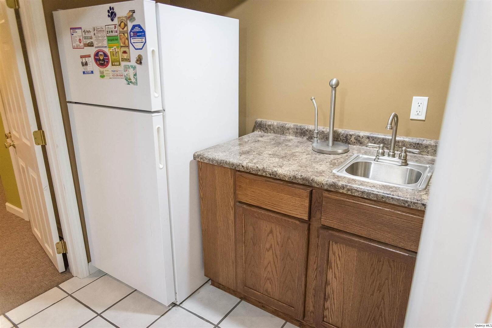 2208 Cherry Lane Quincy, IL 62301 - Photo 9 of 10 a white refrigerator freezer sitting inside of a kitchen