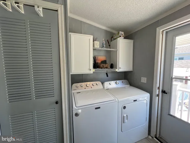 a view of a room with table and chairs