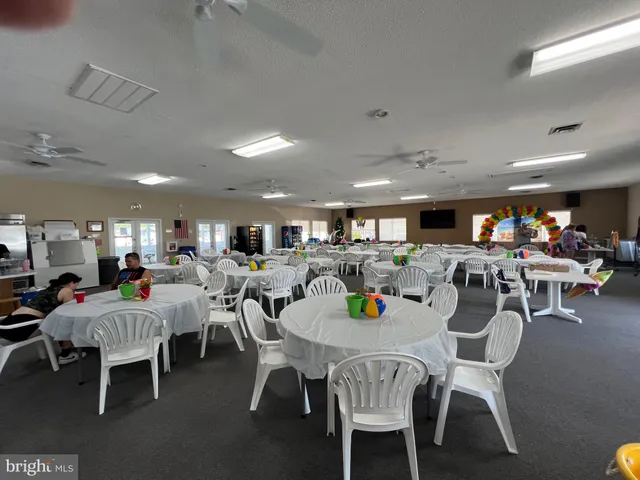 a view of a backyard of the house with a table and chairs