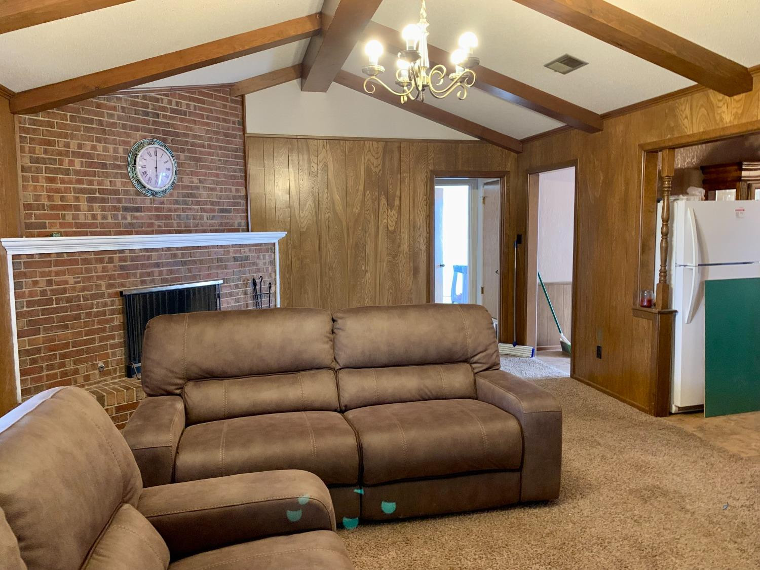1007 17th Street Ralls, TX 79357 - Photo 3 of 12 a living room with furniture and a fireplace