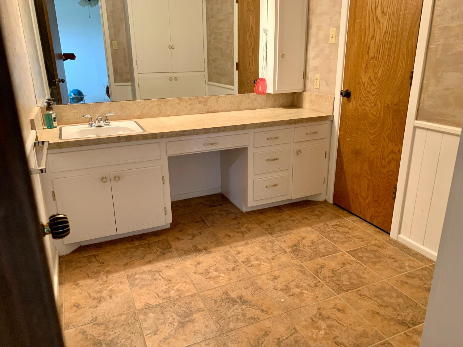1007 17th Street Ralls, TX 79357 - Photo 5 of 12 a bathroom with a sink and a mirror
