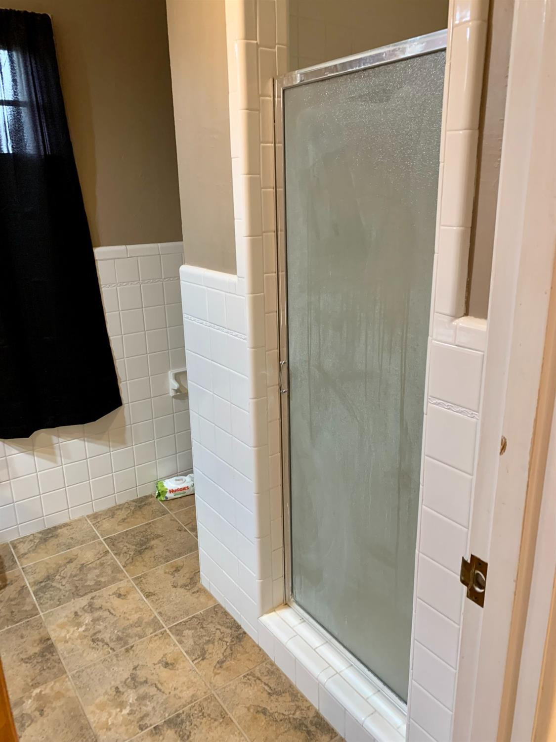 1007 17th Street Ralls, TX 79357 - Photo 6 of 12 a bathroom with a shower and a mirror