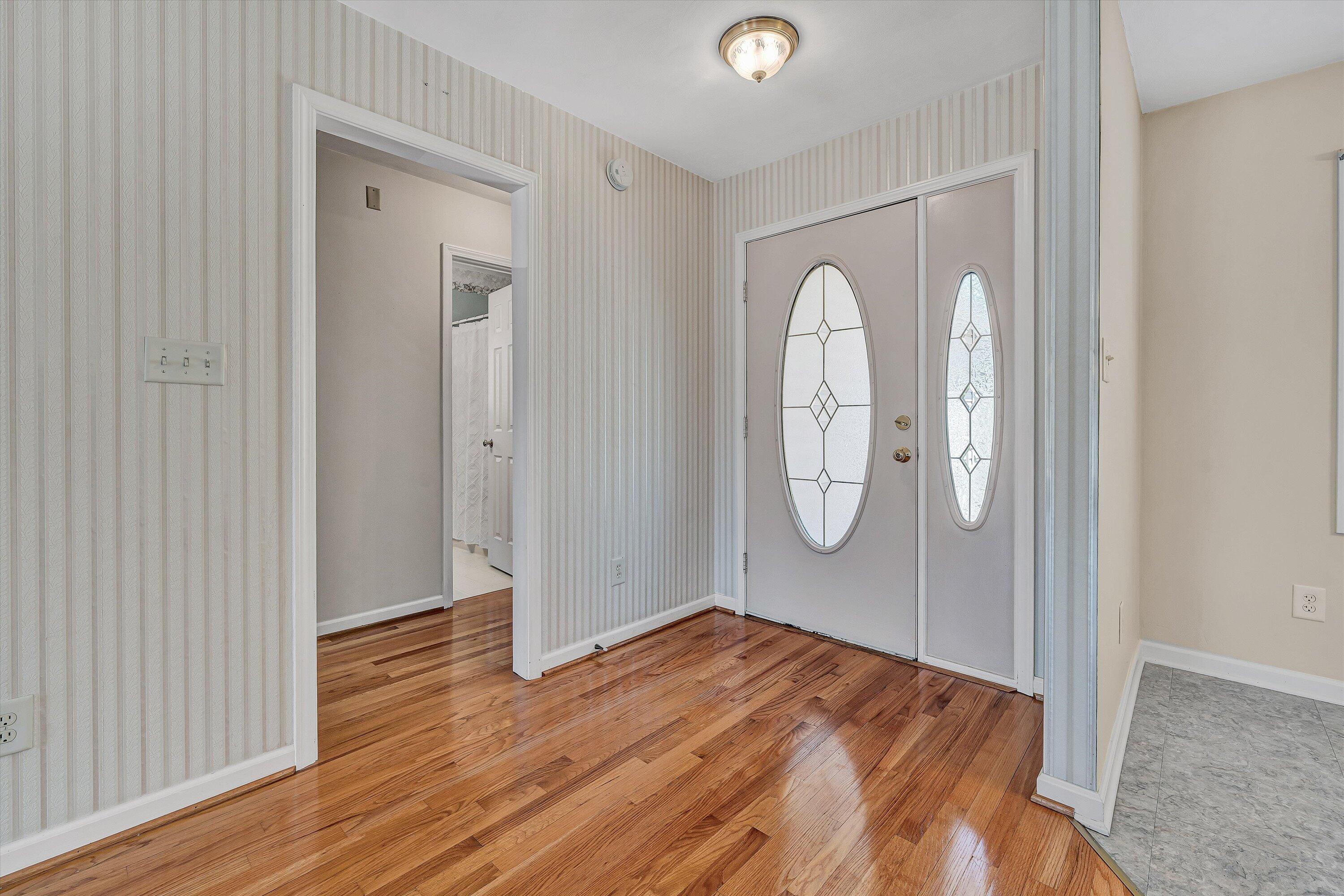 3516 Pinnacle Ridge Road Northeast Roanoke, VA 24012 - Photo 6 of 39 an empty room with wooden floor and mirror