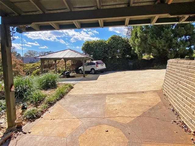 a view of a room with wooden floor and chandelier