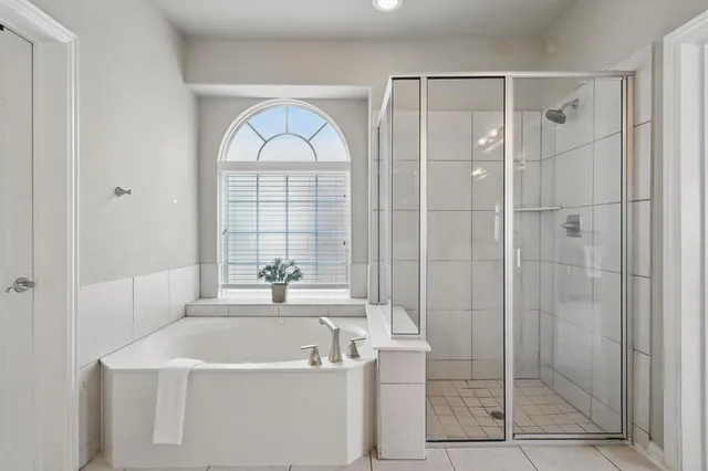 a spacious bathroom with a bathtub a sink and a window