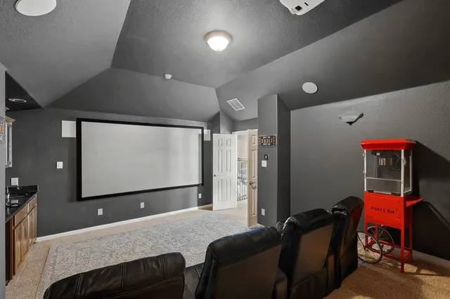 a living room with furniture and a projector screen