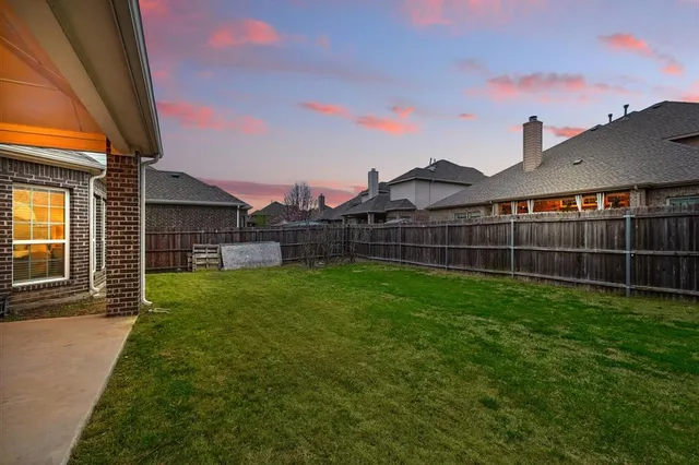 a view of a backyard with a garden and deck