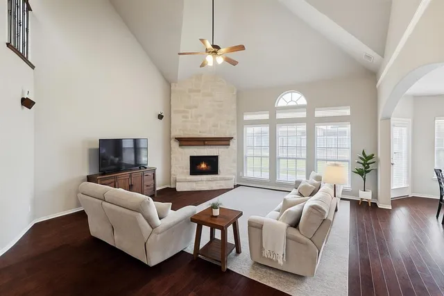 a living room with furniture fireplace and flat screen tv