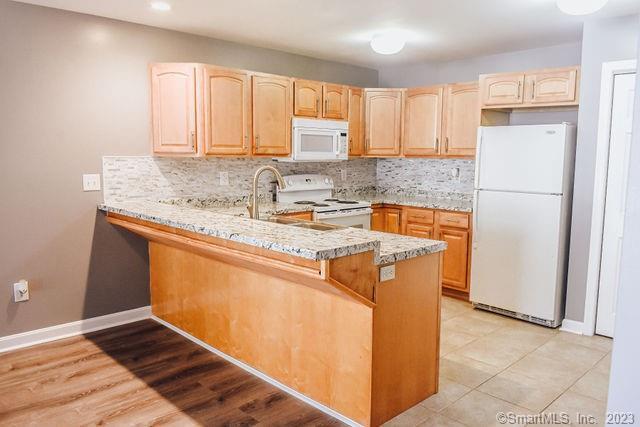 a kitchen with stainless steel appliances granite countertop a refrigerator sink and cabinets
