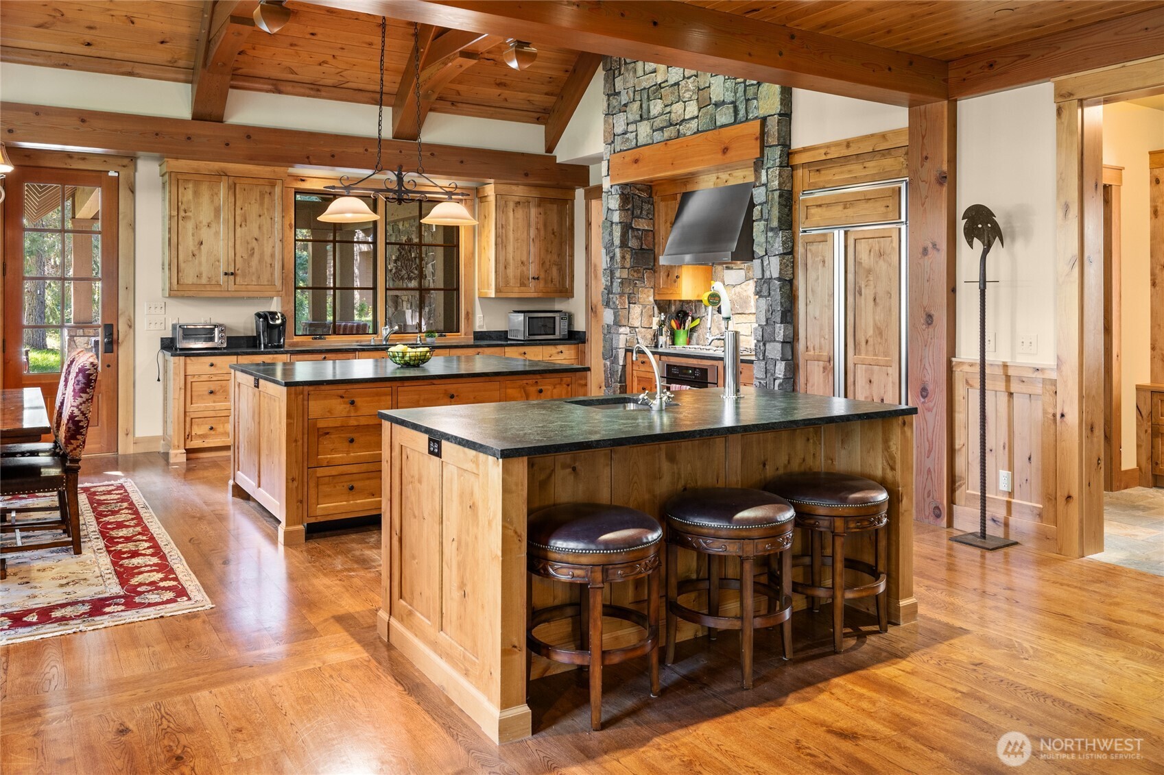 151 Rushing Water Lane Cle Elum, WA 98922 - Photo 12 of 40 a dining hall with stainless steel appliances granite countertop a dining table and chairs with wooden floor