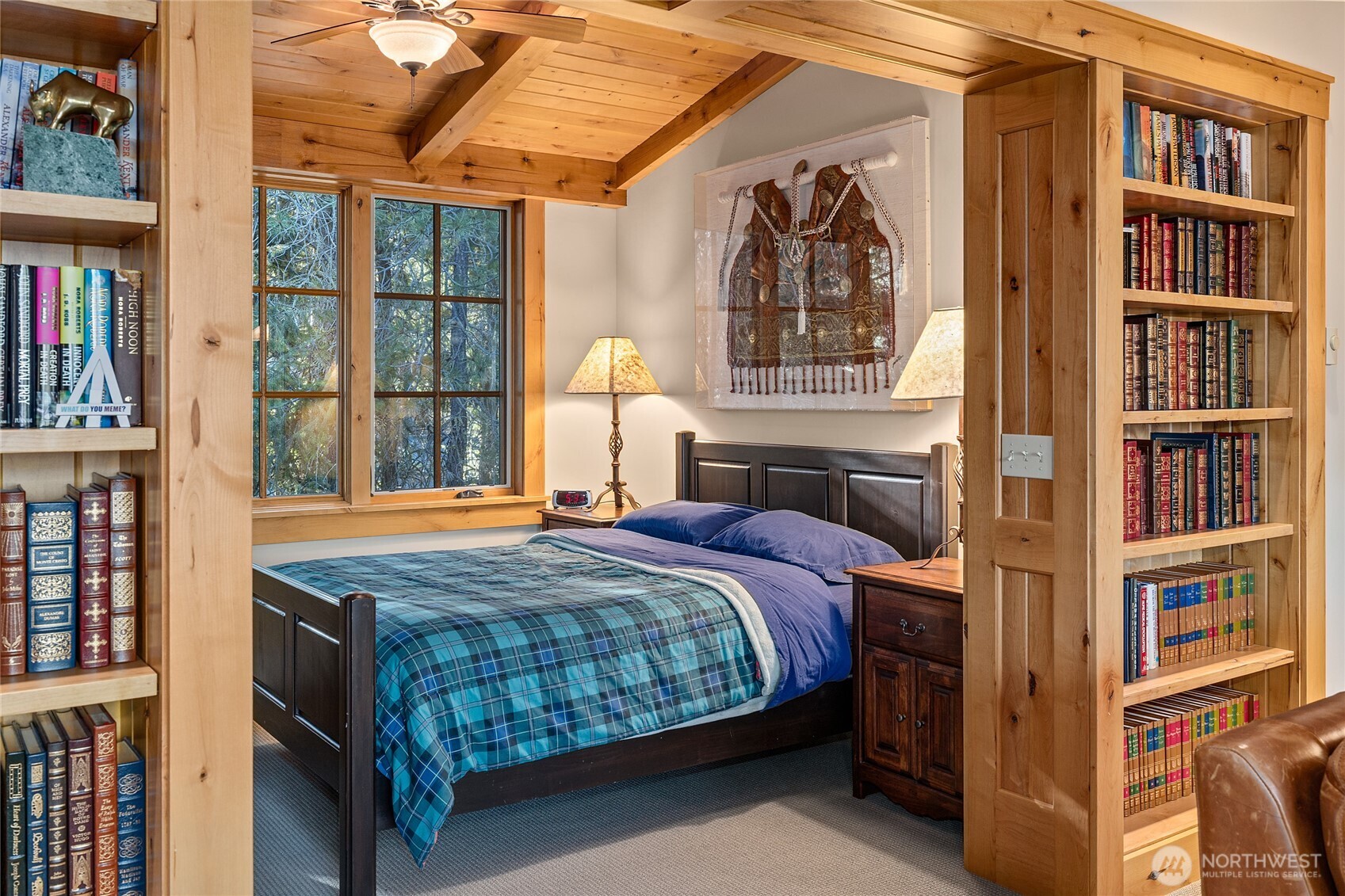 151 Rushing Water Lane Cle Elum, WA 98922 - Photo 32 of 40 a bedroom with a bed a book shelf and a window
