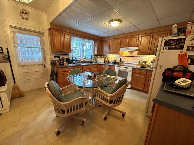 a kitchen with a sink appliances and cabinets