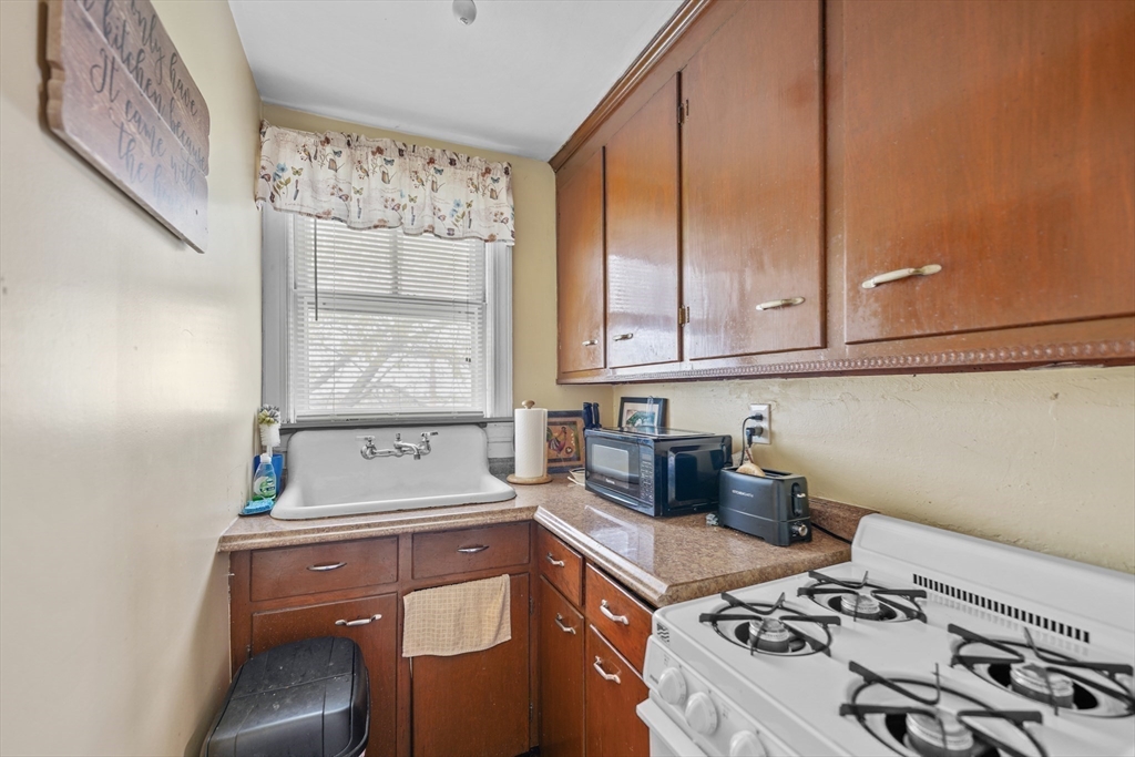 286 Columbia Street Fall River, MA 02721 - Photo 12 of 29 a kitchen with a stove and a white cabinet