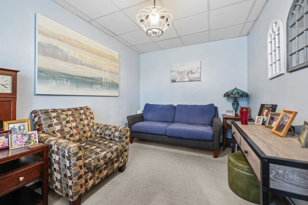 286 Columbia Street Fall River, MA 02721 - Photo 13 of 29 a living room with furniture a couch and paintings on the wall
