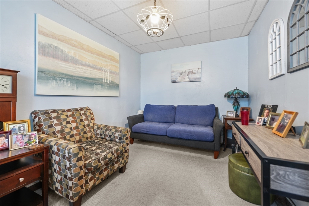 286 Columbia Street Fall River, MA 02721 - Photo 14 of 29 a living room with furniture a couch and paintings on the wall