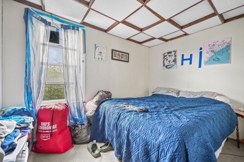286 Columbia Street Fall River, MA 02721 - Photo 16 of 29 a bedroom with a bed and wooden floor
