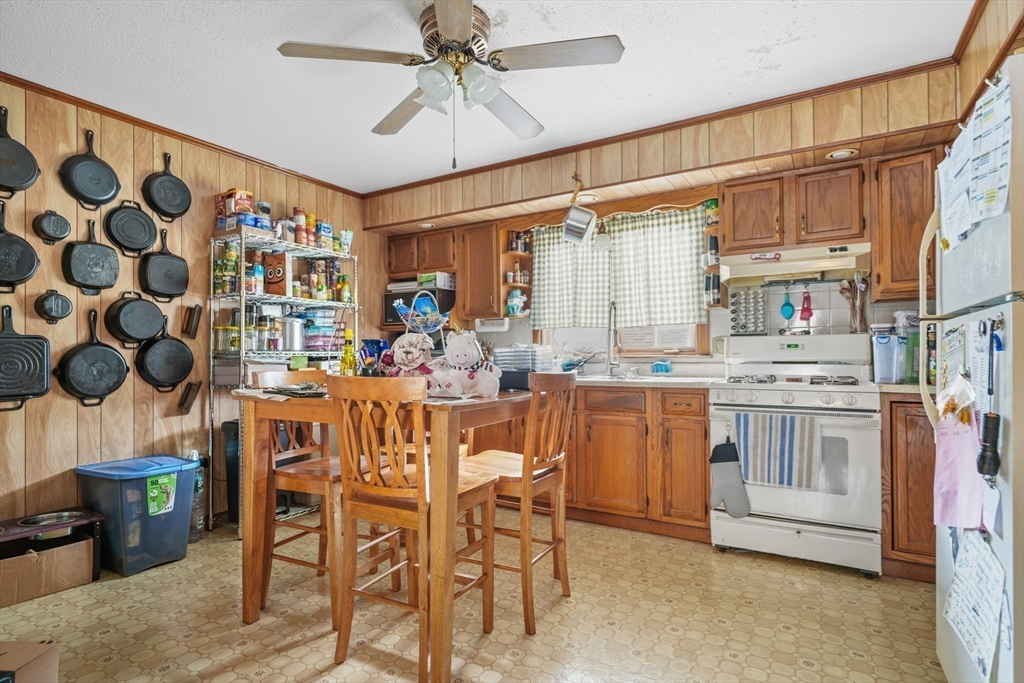 286 Columbia Street Fall River, MA 02721 - Photo 6 of 29 a dining hall with stainless steel appliances kitchen island granite countertop a table and chairs in it
