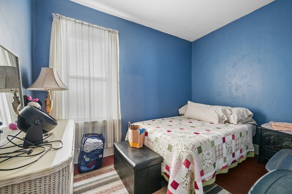 286 Columbia Street Fall River, MA 02721 - Photo 9 of 29 a bedroom with a bed and wooden floor