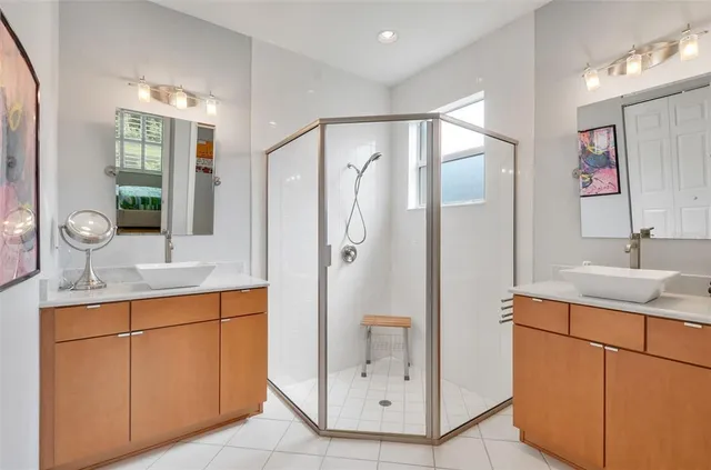 a bathroom with a sink mirror and vanity