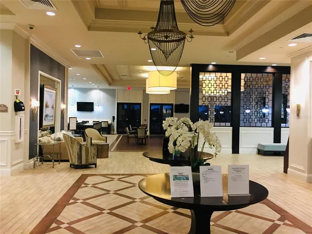 a view of a dining room with furniture wooden floor and chandelier