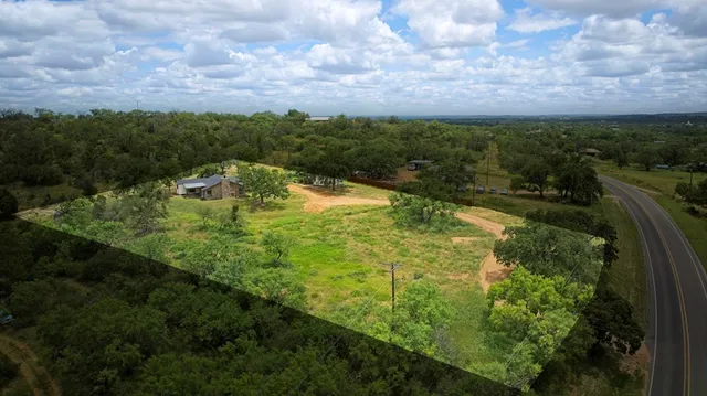 a view of house with swimming pool and trees in the background