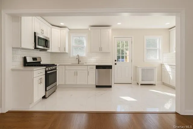 a view of a room with wooden floor and bathroom
