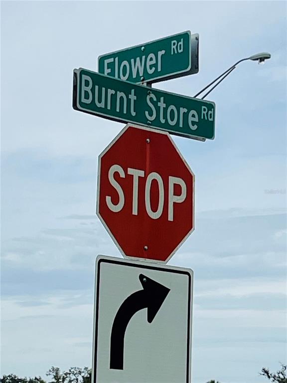 26153 Flower Road Punta Gorda, FL 33955 - Photo 6 of 6 a close up of a street sign