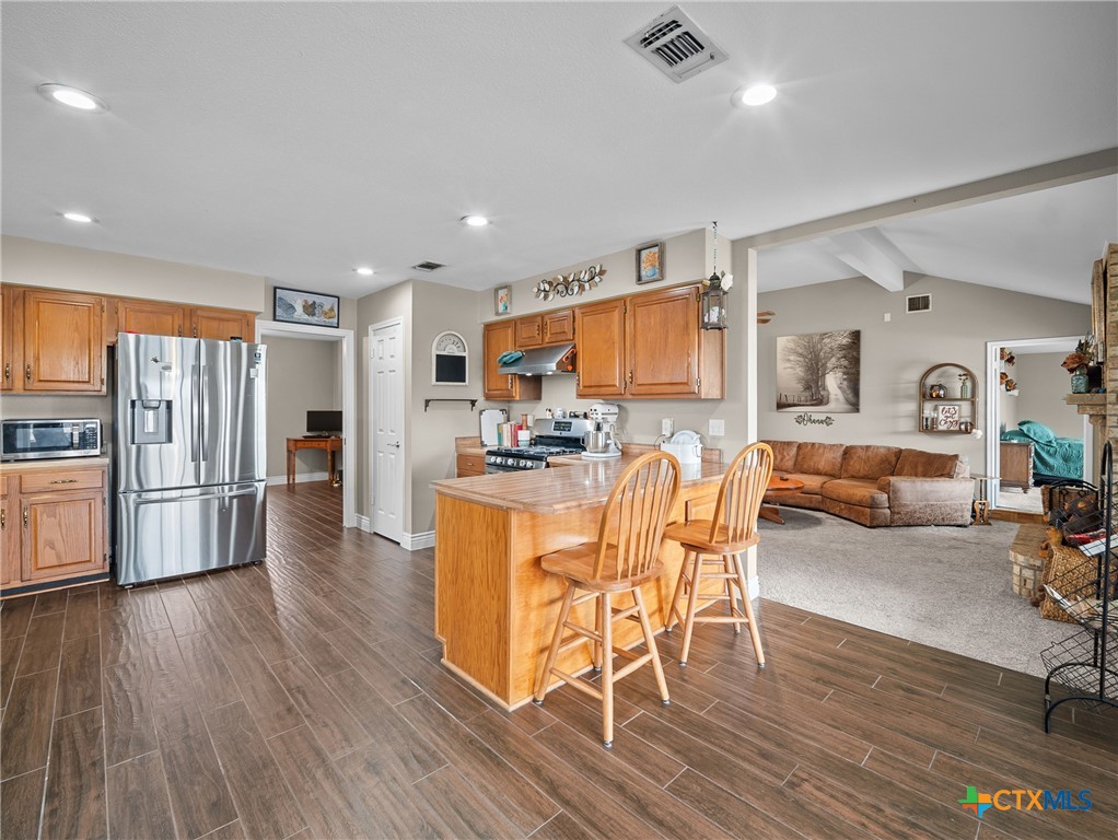 782 Santa Clara Loop Marion, TX 78124 - Photo 29 of 48 a view of kitchen dining space with furniture and wooden floor