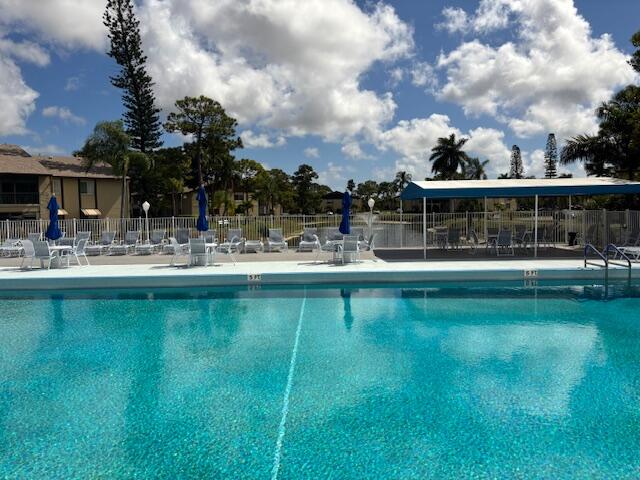 340 Pine Ridge Circle, Unit B1 Greenacres, FL 33463 - Photo 16 of 21 a swimming pool view with a lake view