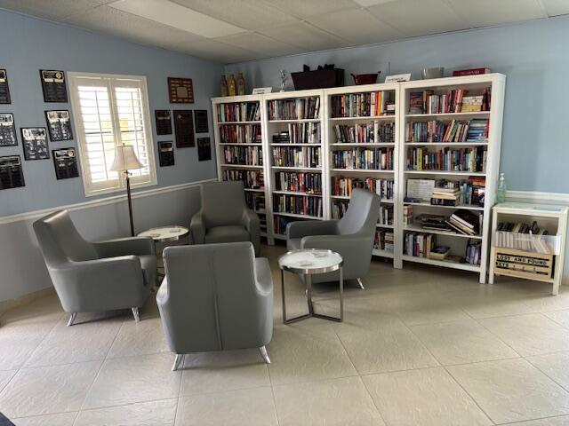 340 Pine Ridge Circle, Unit B1 Greenacres, FL 33463 - Photo 17 of 21 a living room with furniture and a bookshelf