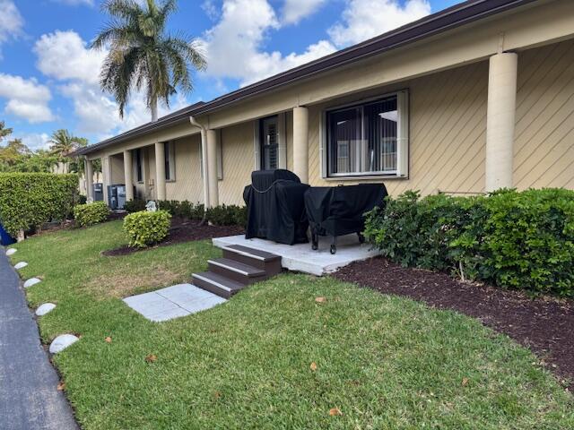 340 Pine Ridge Circle, Unit B1 Greenacres, FL 33463 - Photo 21 of 21 a front view of house with yard and outdoor seating