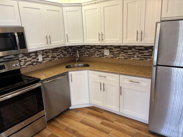 340 Pine Ridge Circle, Unit B1 Greenacres, FL 33463 - Photo 5 of 21 a kitchen with granite countertop white cabinets and refrigerator