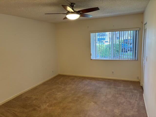 340 Pine Ridge Circle, Unit B1 Greenacres, FL 33463 - Photo 9 of 21 an empty room with a window and a fan