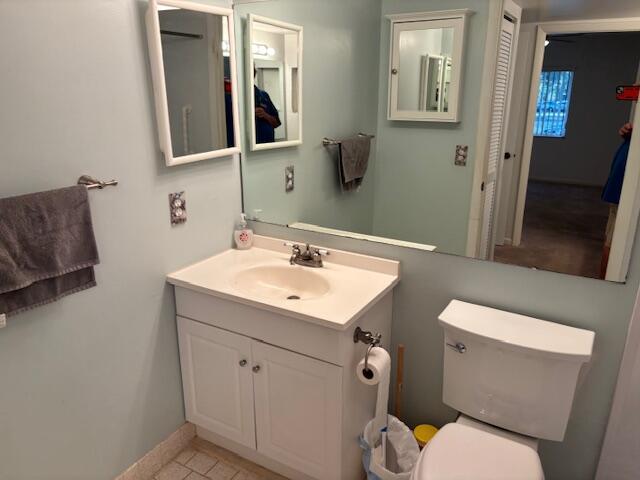 340 Pine Ridge Circle, Unit B1 Greenacres, FL 33463 - Photo 10 of 21 a bathroom with a sink mirror vanity and toilet