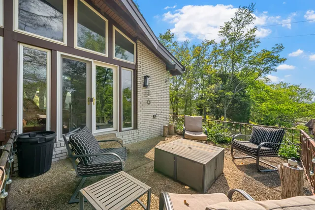 a view of a patio with couple of chairs and a couch