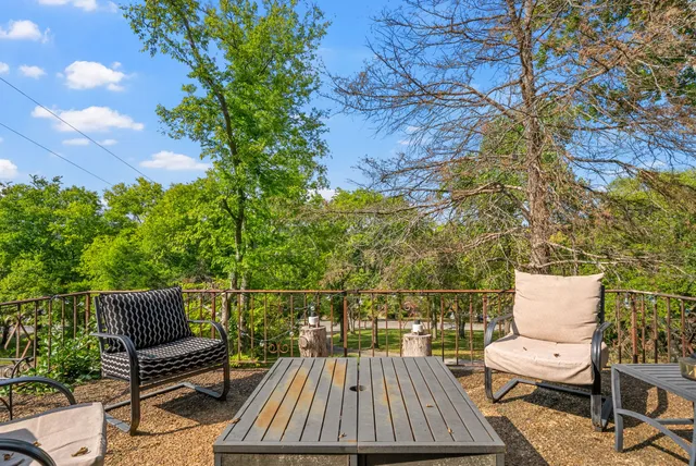 a view of roof deck with chairs and wooden floor