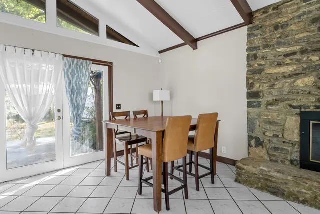 a dining room with furniture and a fireplace