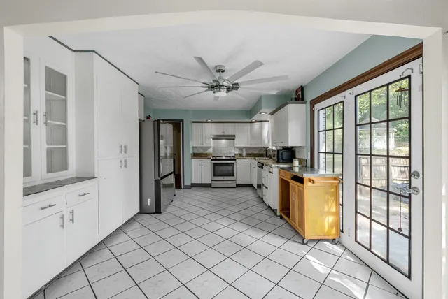 a view of a kitchen with microwave and refrigerator
