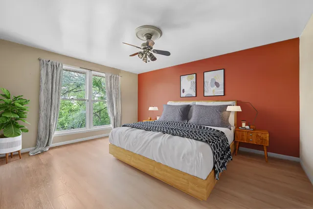 a spacious bedroom with a bed and a large window