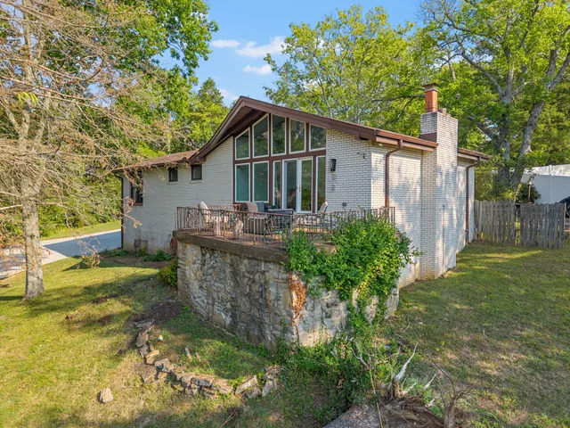 a front view of house with yard and trees