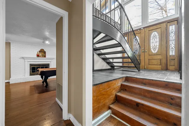 a view of entryway and hall with wooden floor