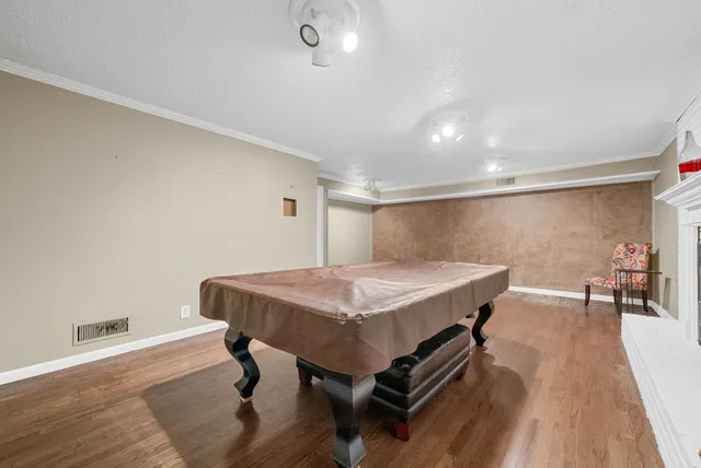 a view of a room with furniture and wooden floor