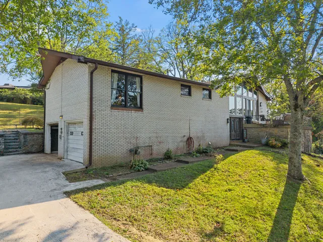a backyard of a house with yard and outdoor seating