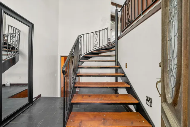 a view of staircase with lots of frames on wall