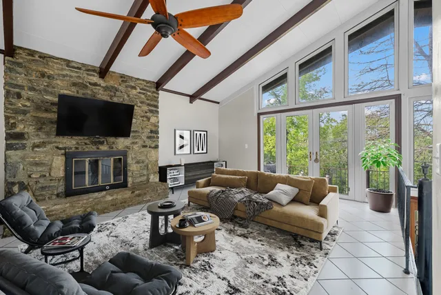 a living room with furniture a flat screen tv and a fireplace