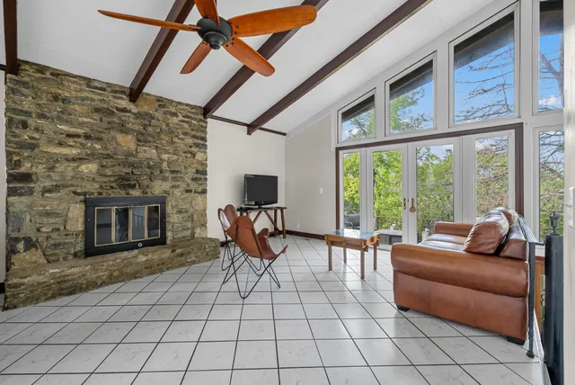 a living room with furniture a flat screen tv and a fireplace