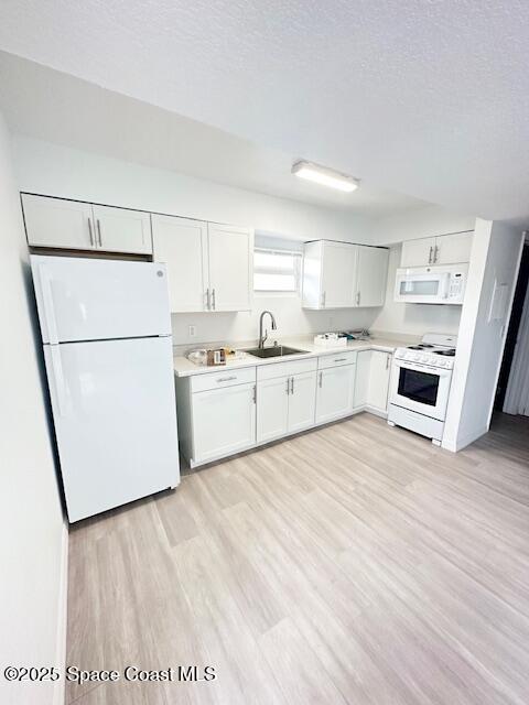 1042 Sea Grape Drive, Unit 201 Melbourne, FL 32935 - Photo 2 of 6 a kitchen with stainless steel appliances granite countertop a refrigerator sink and white cabinets